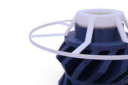 Lamp base component – dark blue helical rotor with translucent radial disc, shown from above
