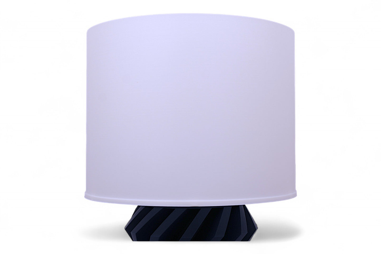 Table lamp with a white shade and blue base on a white background