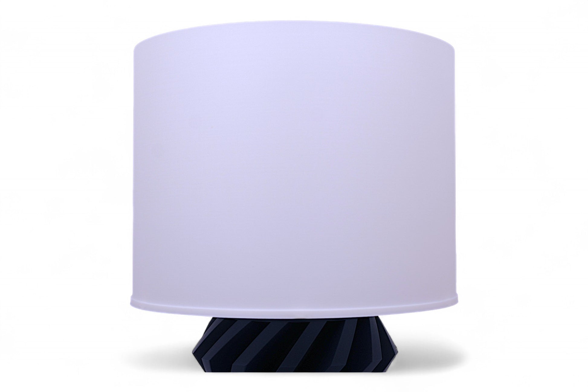Table lamp with a white shade and blue base on a white background
