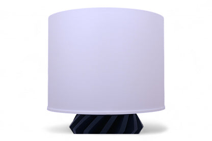 Table lamp with a white shade and blue base on a white background