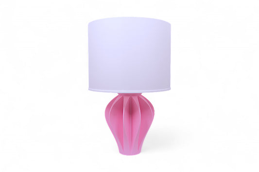 Table lamp – white pleated lampshade with sculptural pink petal-like base, shown against white background
