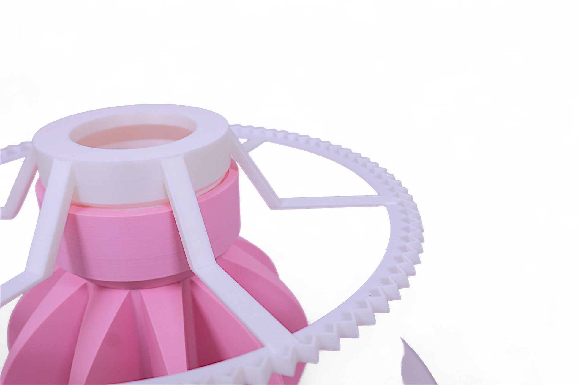 Lamp base component – pink fluted cylindrical base with white gear-like ring and radial arms, shown close-up