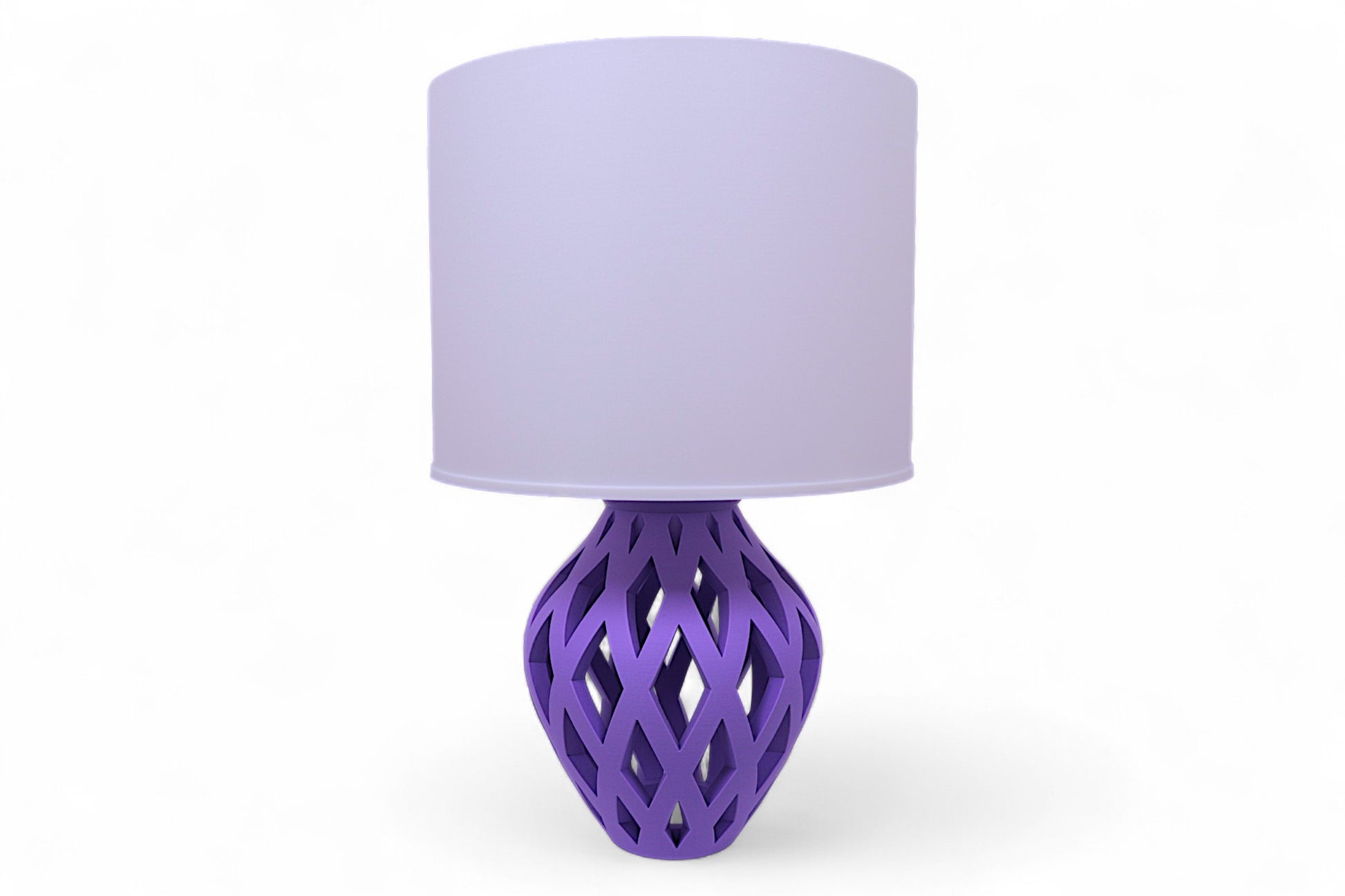 Table lamp – white cylindrical lampshade with sculptural purple lattice-style base, elongated diamond cutouts
