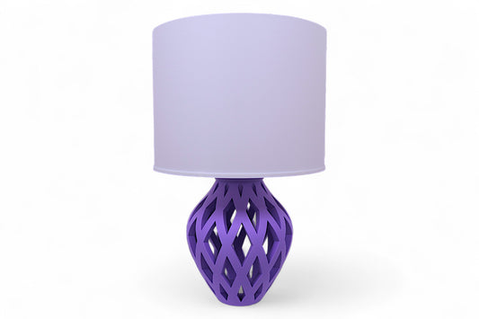 Table lamp – white cylindrical lampshade with sculptural purple lattice-style base, elongated diamond cutouts
