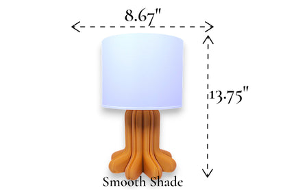 Table lamp – smooth white cylindrical lampshade with sculptural wood-tone base, 8.67" diameter × 13.75" height, labeled “Smooth Shade”
