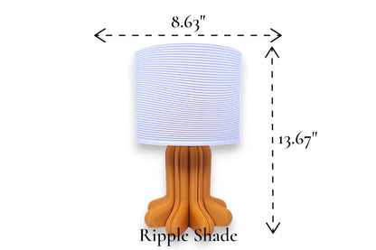 Table lamp – white ripple-textured lampshade with sculptural orange-brown petal-style base, 8.63" diameter × 13.67" height, labeled “Ripple Shade”
