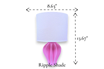 Table lamp – white ripple-textured cylindrical lampshade with sculptural pink base, 8.63" diameter × 13.67" height, labeled “Ripple Shade”

