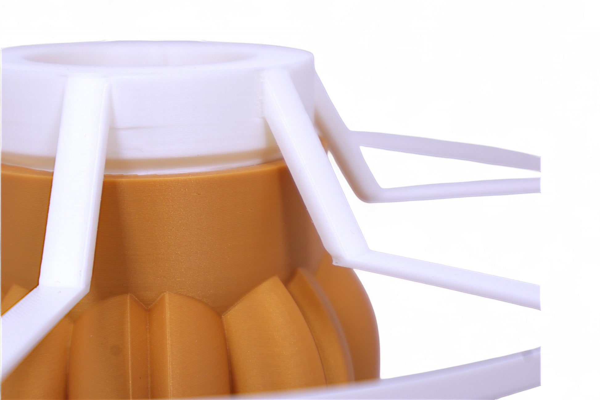 Table lamp – white cylindrical lampshade with sculptural wood-tone base, rounded tubular segments forming stable support
