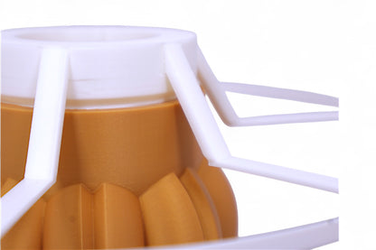 Table lamp – white cylindrical lampshade with sculptural wood-tone base, rounded tubular segments forming stable support
