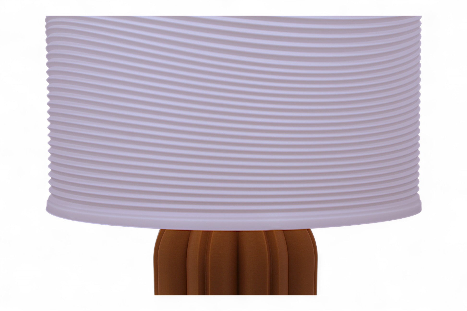 Table lamp – white ripple-textured lampshade with sculptural orange-brown petal-like base, labeled “Ripple Shade”
