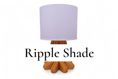 Table lamp – white ripple-textured lampshade with sculptural orange-brown petal-like base, labeled “Ripple Shade”
