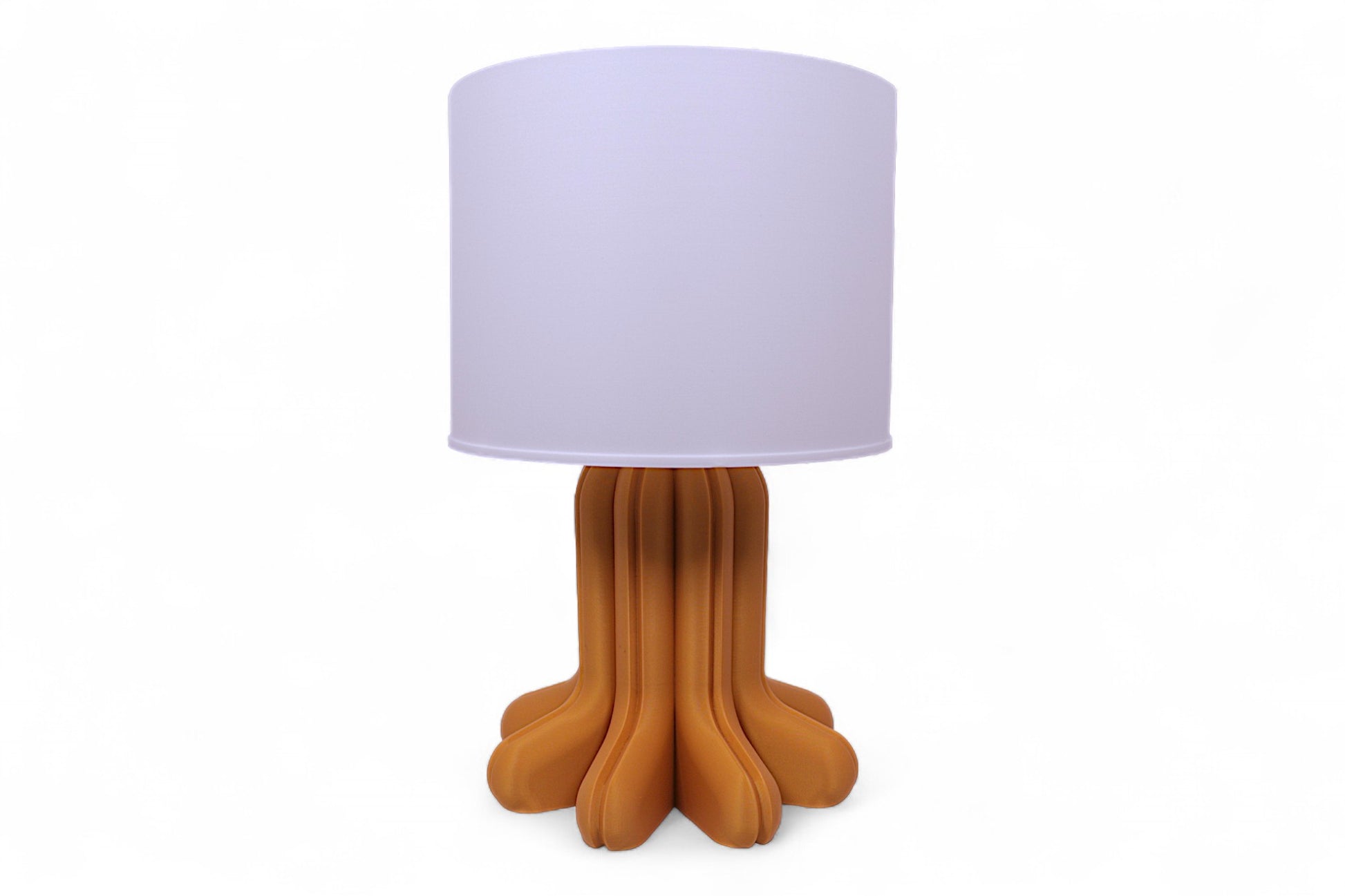 Table lamp – white cylindrical lampshade with sculptural wood-tone base, rounded tubular segments forming stable support
