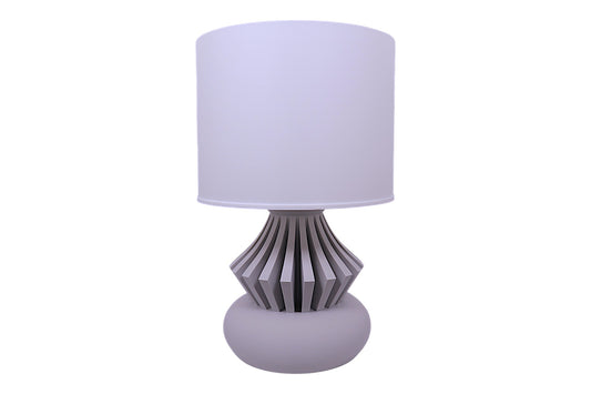 Table lamp with a white shade and decorative base on a white background