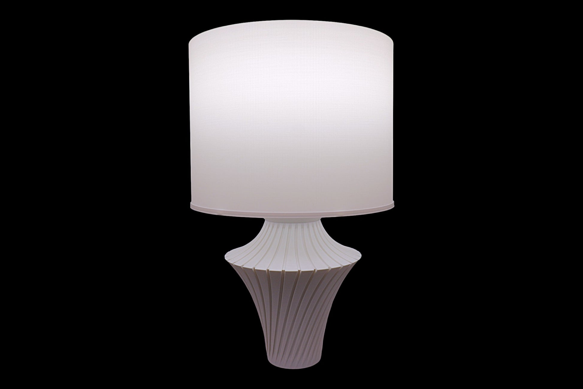 White table lamp with a textured base on a black background