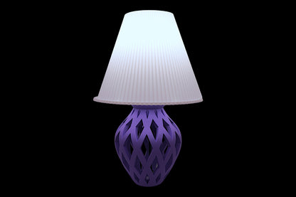 Table lamp – lavender ripple-textured cylindrical lampshade with sculptural purple lattice-style base, shown glowing
