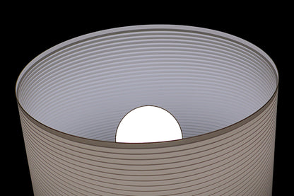 Cylindrical container with a white sphere inside on a black background