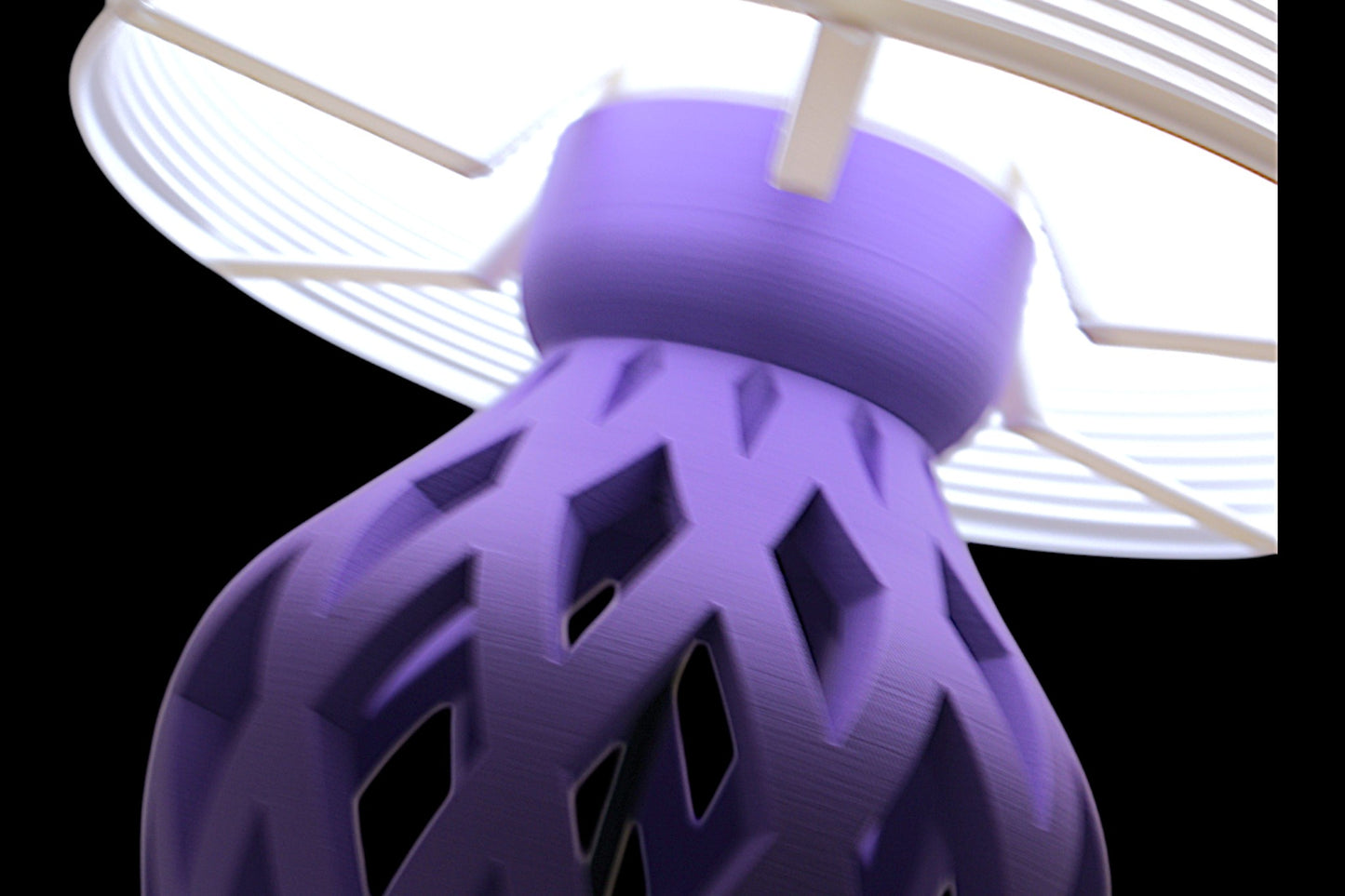 Close-up of a purple textured object with geometric patterns against a white background