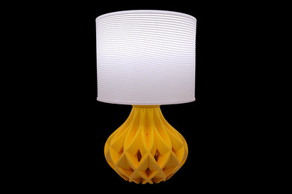 Table lamp – white ripple-textured cylindrical lampshade with sculptural yellow geometric base, labeled “Ripple Shade”
