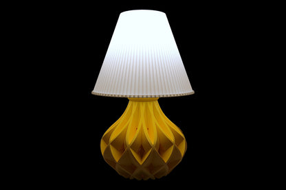 Table lamp – white pleated lampshade with sculptural yellow lattice-style base, labeled “Vima Shade”
