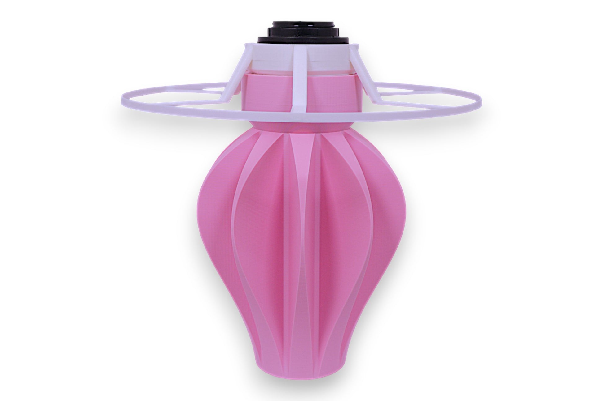 Table lamp – white cylindrical lampshade with sculptural pink fluted base, shown against black background
