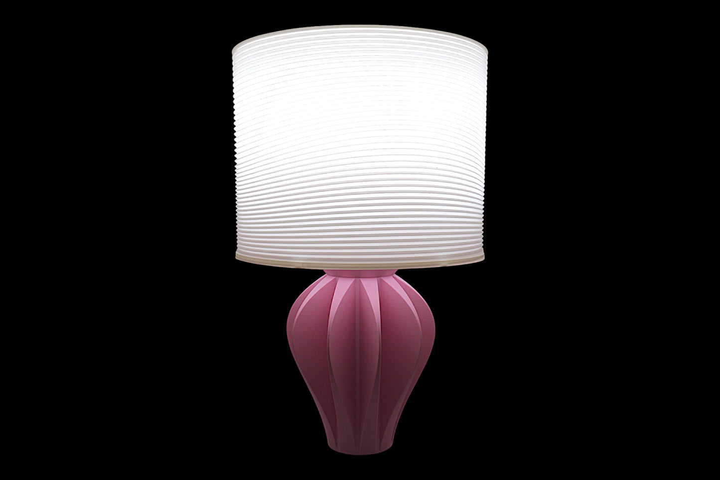 Pink table lamp with a white lampshade on a black background
