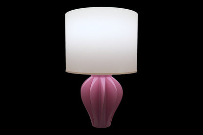 Pink table lamp with a white shade on a black background