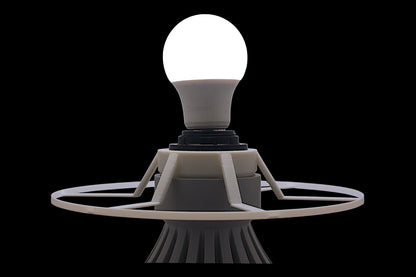 Light bulb on a futuristic base against a black background