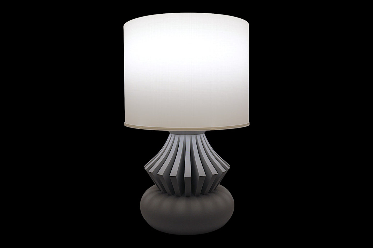Table lamp with a white shade and decorative base on a black background