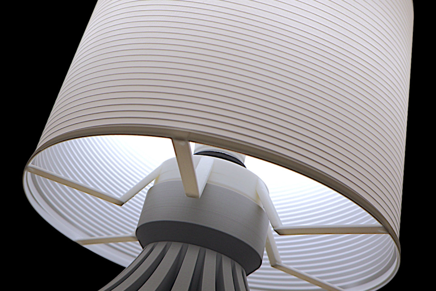 Close-up of a lamp with a white shade on a black background