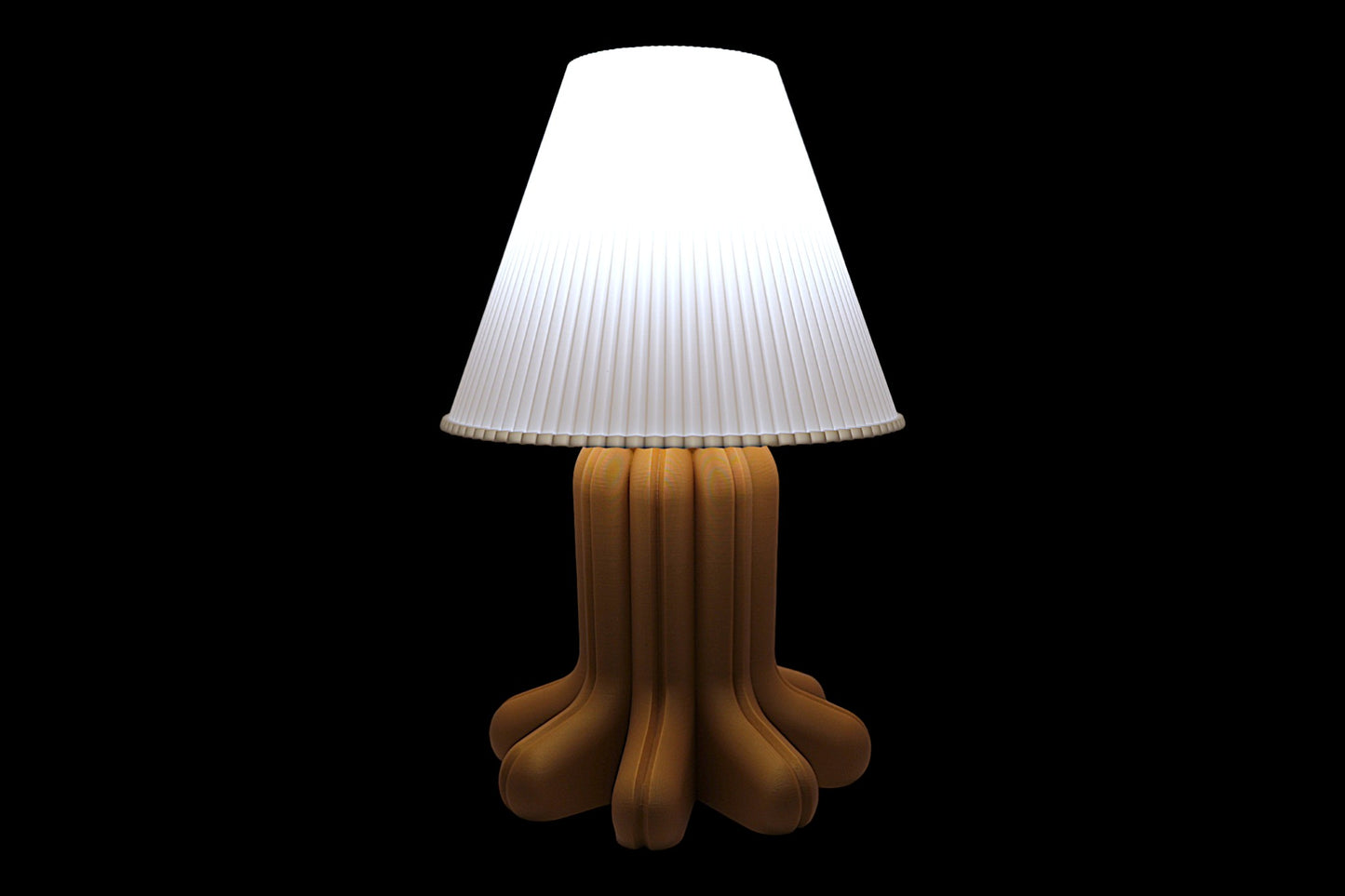 Lamp with a white shade and brown base on a black background