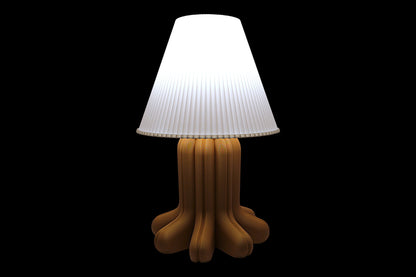 Lamp with a white shade and brown base on a black background