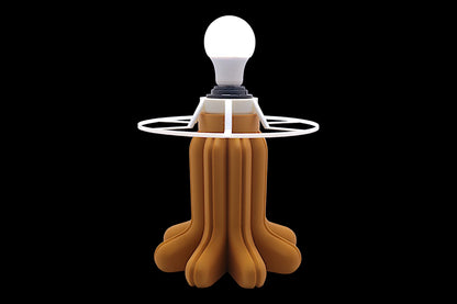Lamp base component – glowing white bulb with black socket, white radial stabilizer ring, and sculptural gold petal-like base
