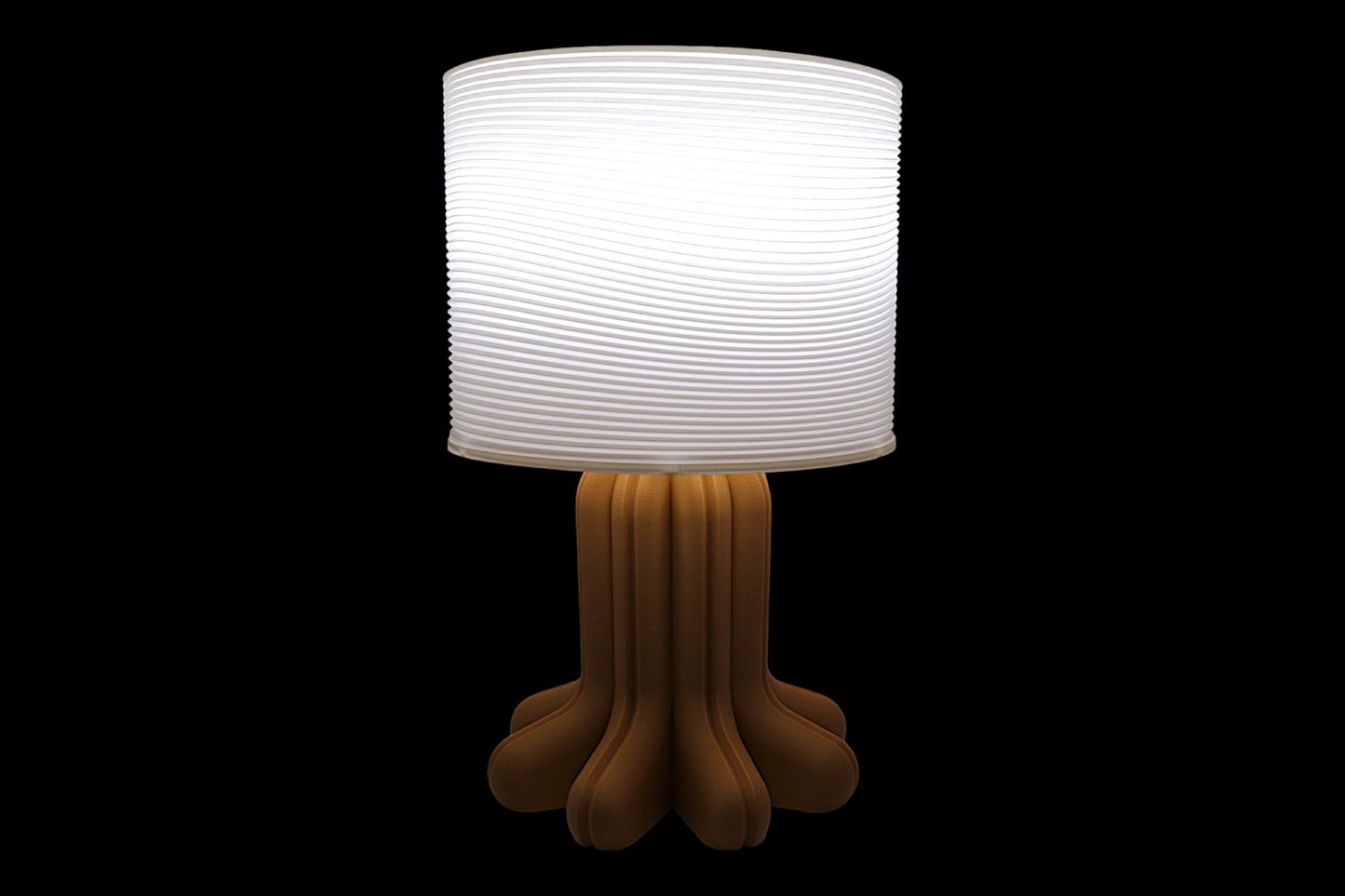 Table lamp with a white shade and brown base on a black background