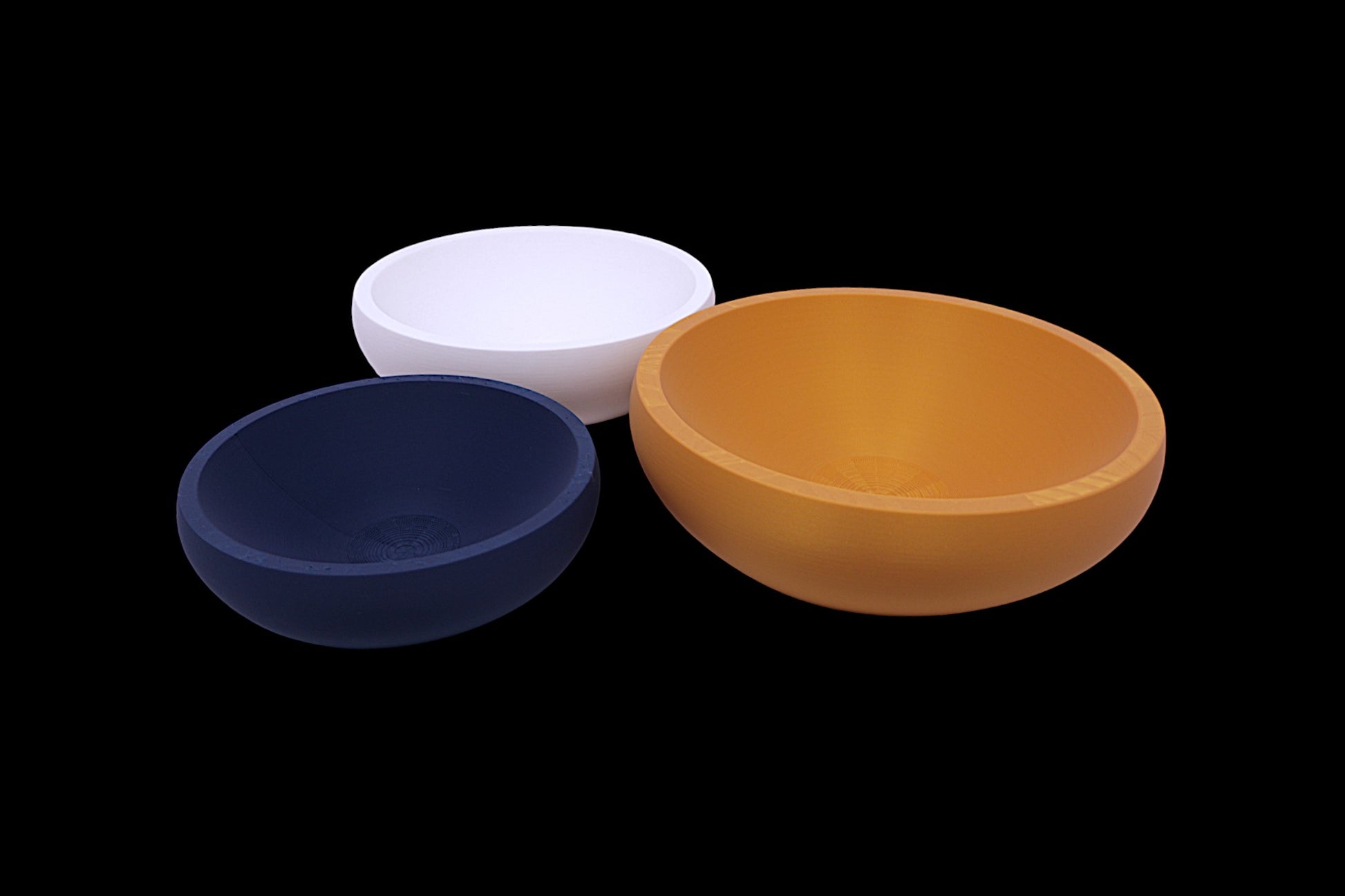 Catch-all trays – 3-pack set in navy blue, light pink, and orange PLA, round shape with smooth finish, shown empty
