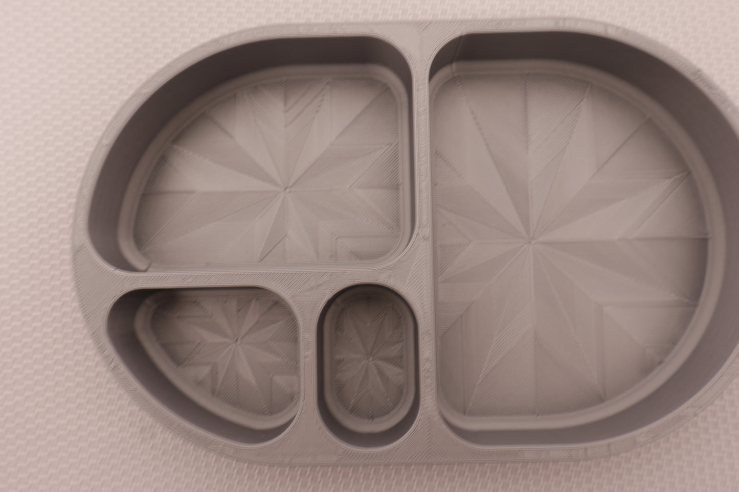 Compartment tray – silver PLA with four sections, geometric starburst pattern, shown empty
