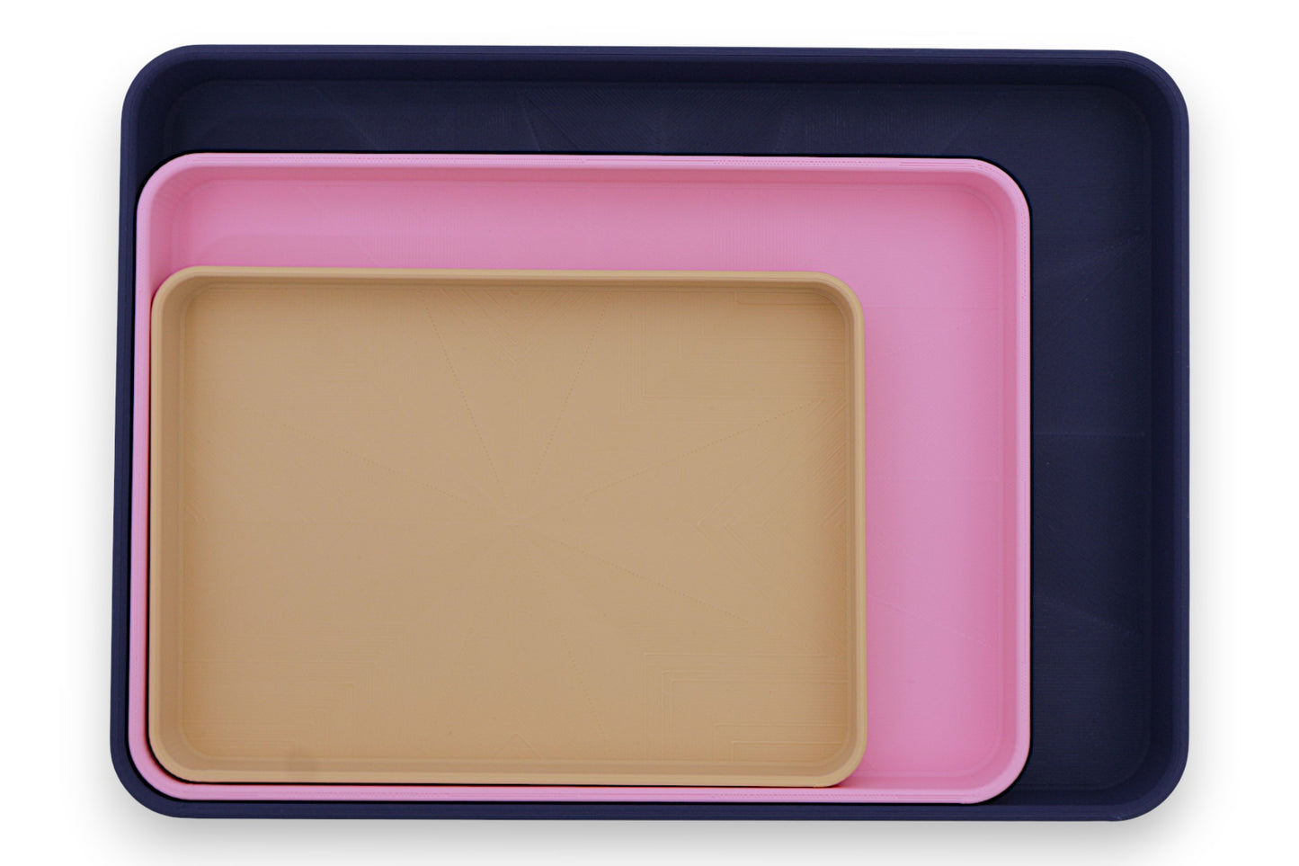Catch-all trays – 3-pack set in dark blue, pink, and beige PLA, nested for size comparison
