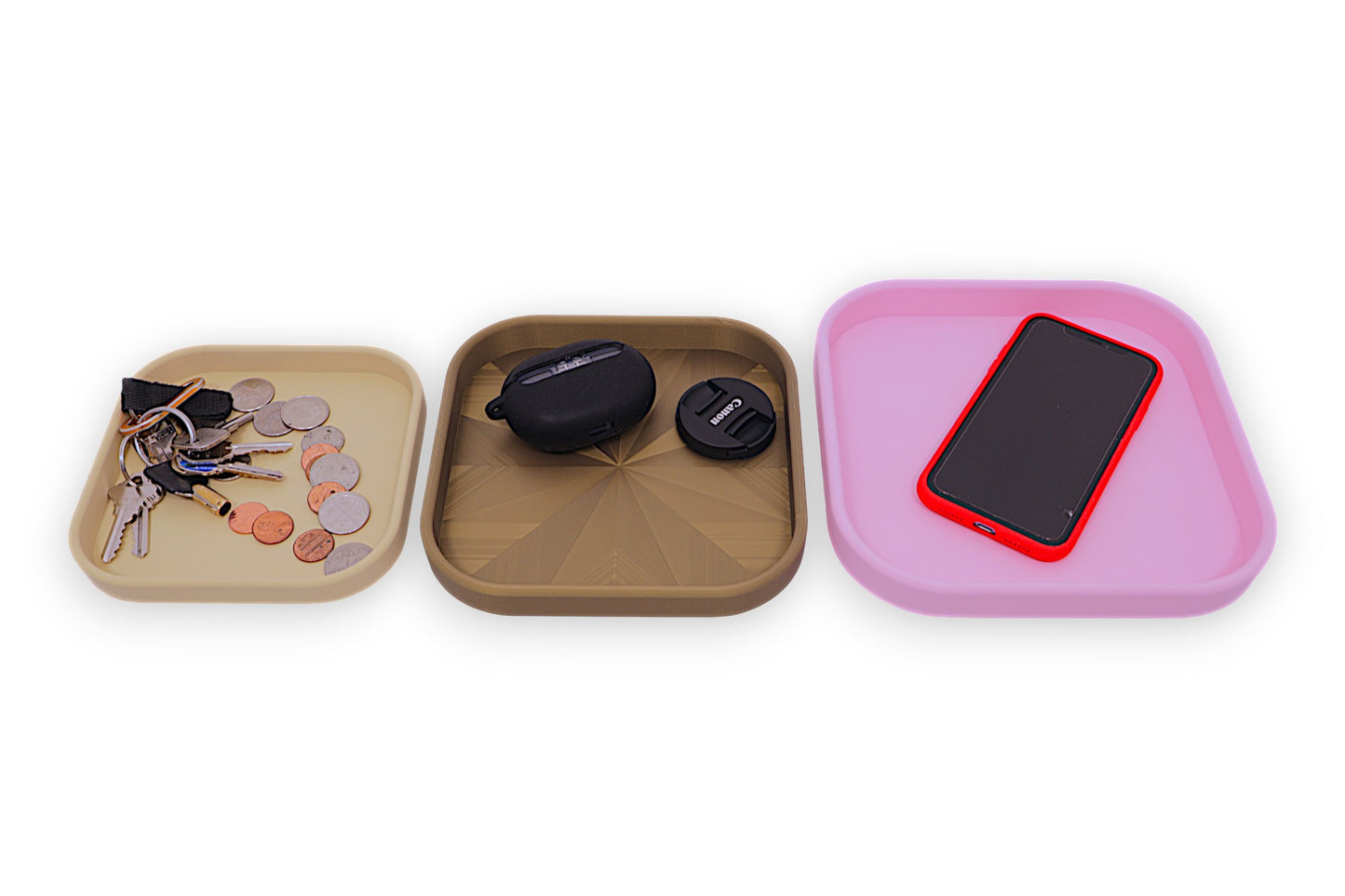 Catch-all trays – 3-pack set in beige, dark green, and pink PLA, shown with coins, keys, earbuds, phone, and lens cap
