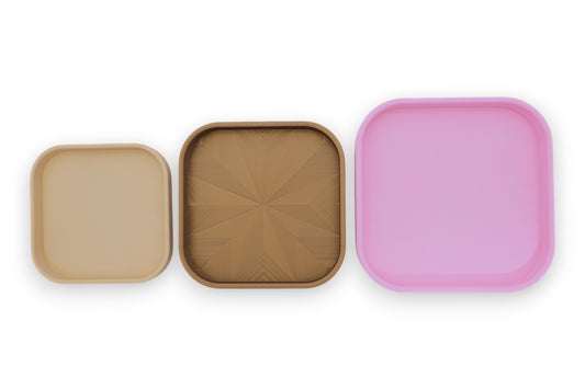 Catch-all trays – 3-pack set in beige, bronze, and pink PLA, square shape with rounded corners, shown side by side

