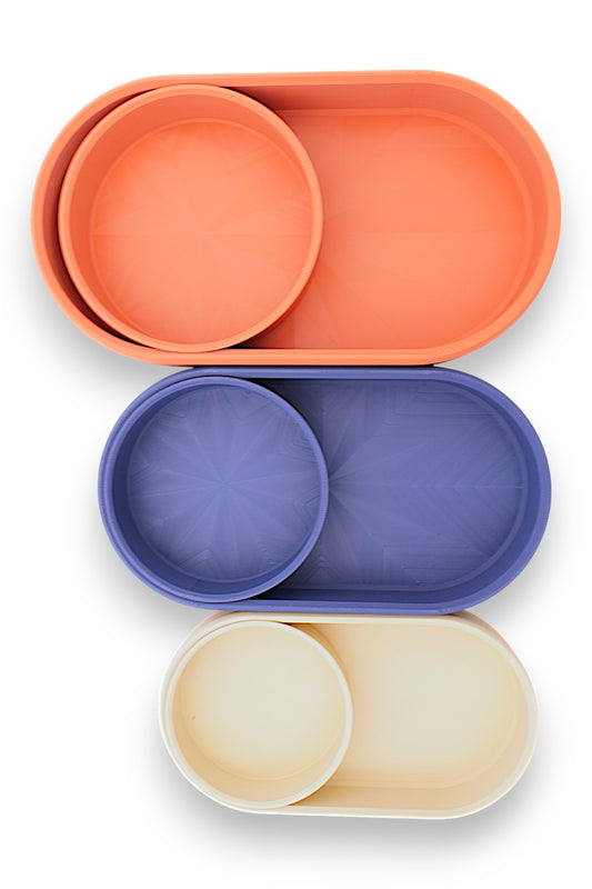 Catch-all trays – 3 nested sets in orange, blue, and cream PLA, each with 1 round tray inside oval base, radial base pattern
