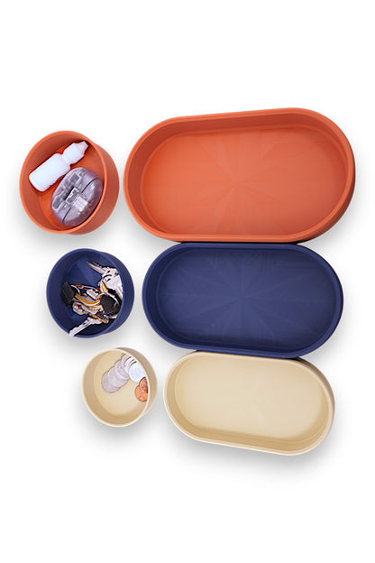 Catch-all trays – 3-pack set in cream, navy blue, and terracotta PLA, shown with coins, keys, brush, bottle, and small items