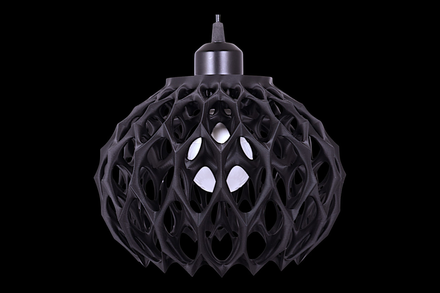 Black spherical pendant light with cellular lattice shell and visible bulb