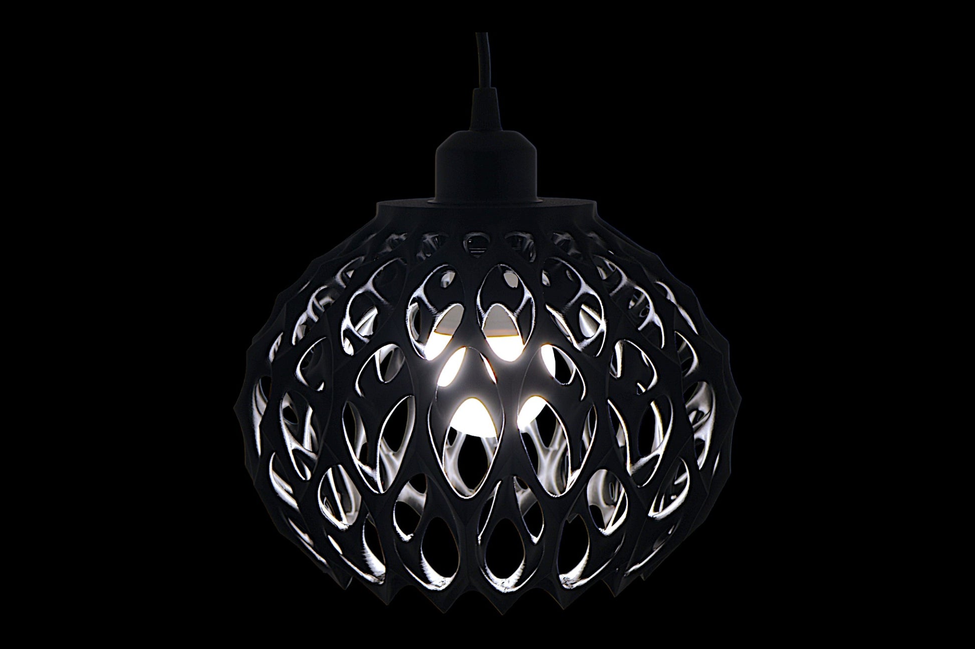 Black spherical pendant light with cellular lattice shell and visible bulb