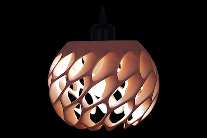 Pendant lamp – 3D printed with amber shell and overlapping scale-like cutouts, glowing bulb casts soft light