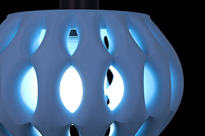 Close-up of a futuristic, blue-lit object with geometric design on a black background