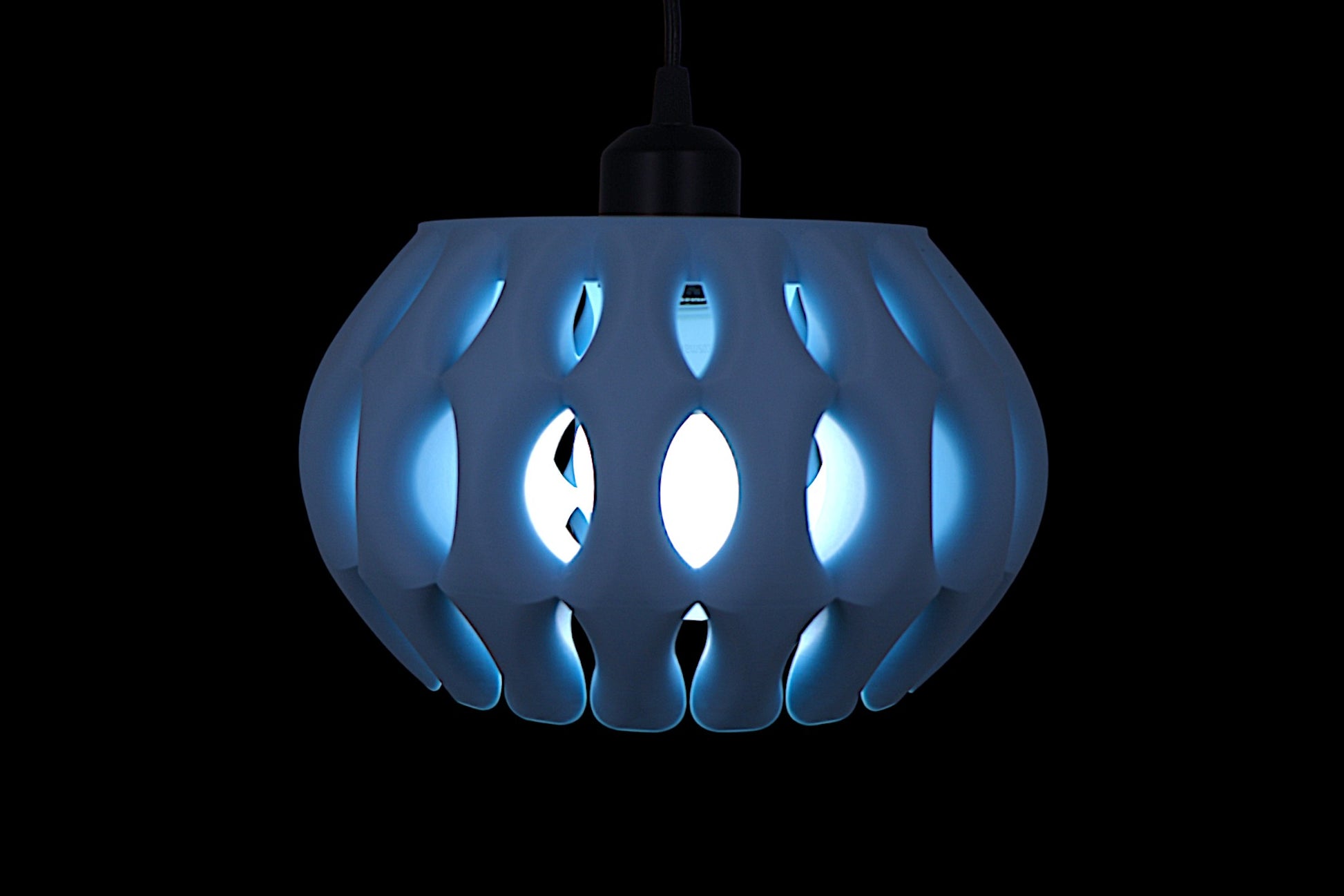 Pendant lamp – 3D printed in ice blue PLA with cage-style shell, curved symmetrical segments surround glowing bulb
