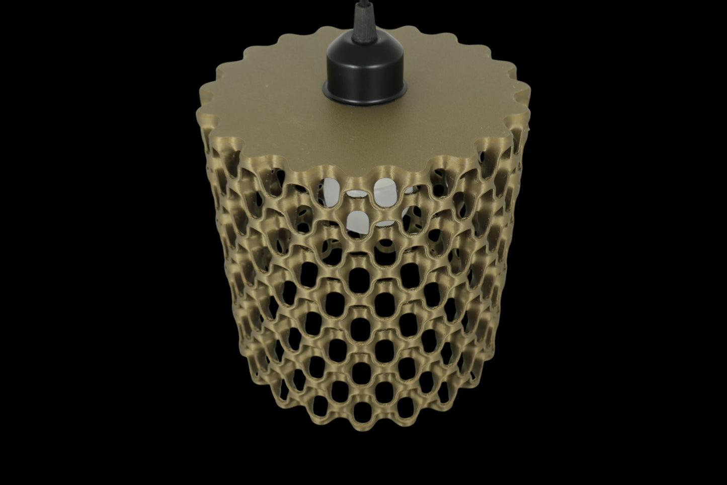 3D-printed object with honeycomb design on a black background