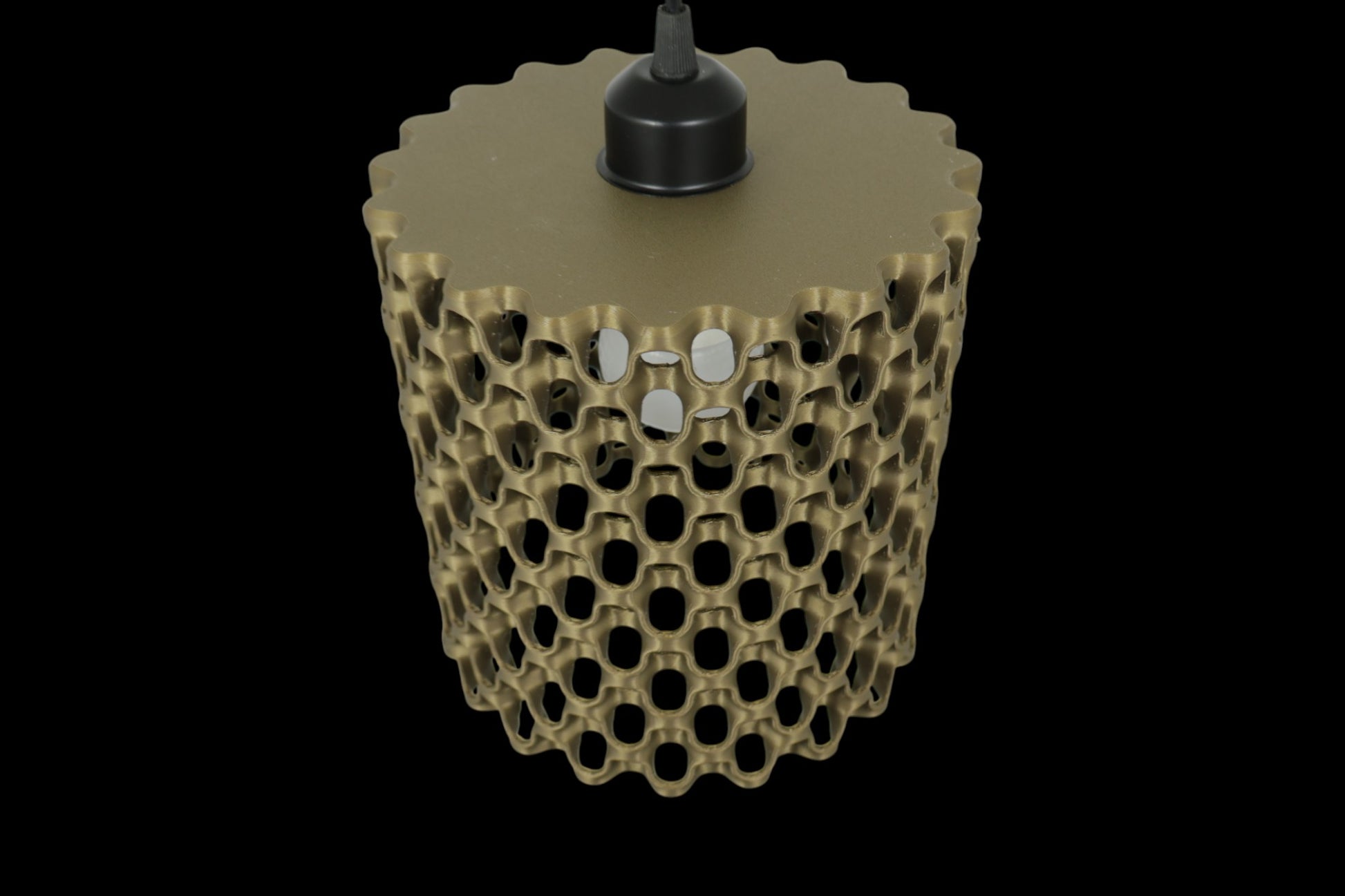 3D-printed object with honeycomb design on a black background