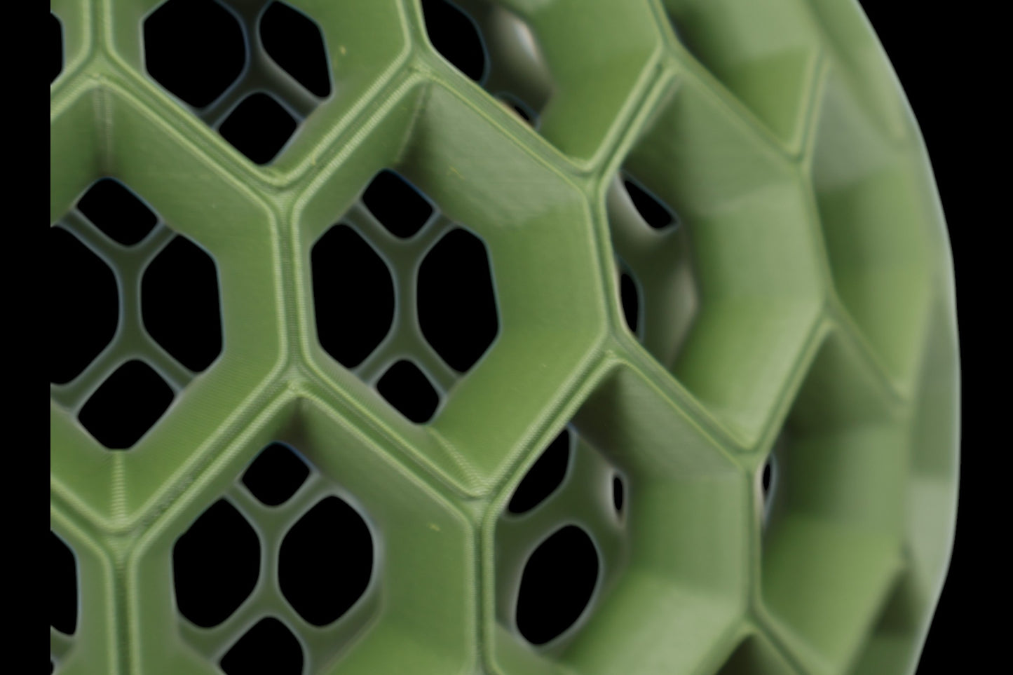 Pendant lamp – 3D printed with green honeycomb shell featuring hexagonal and pentagonal openings, black top mount
