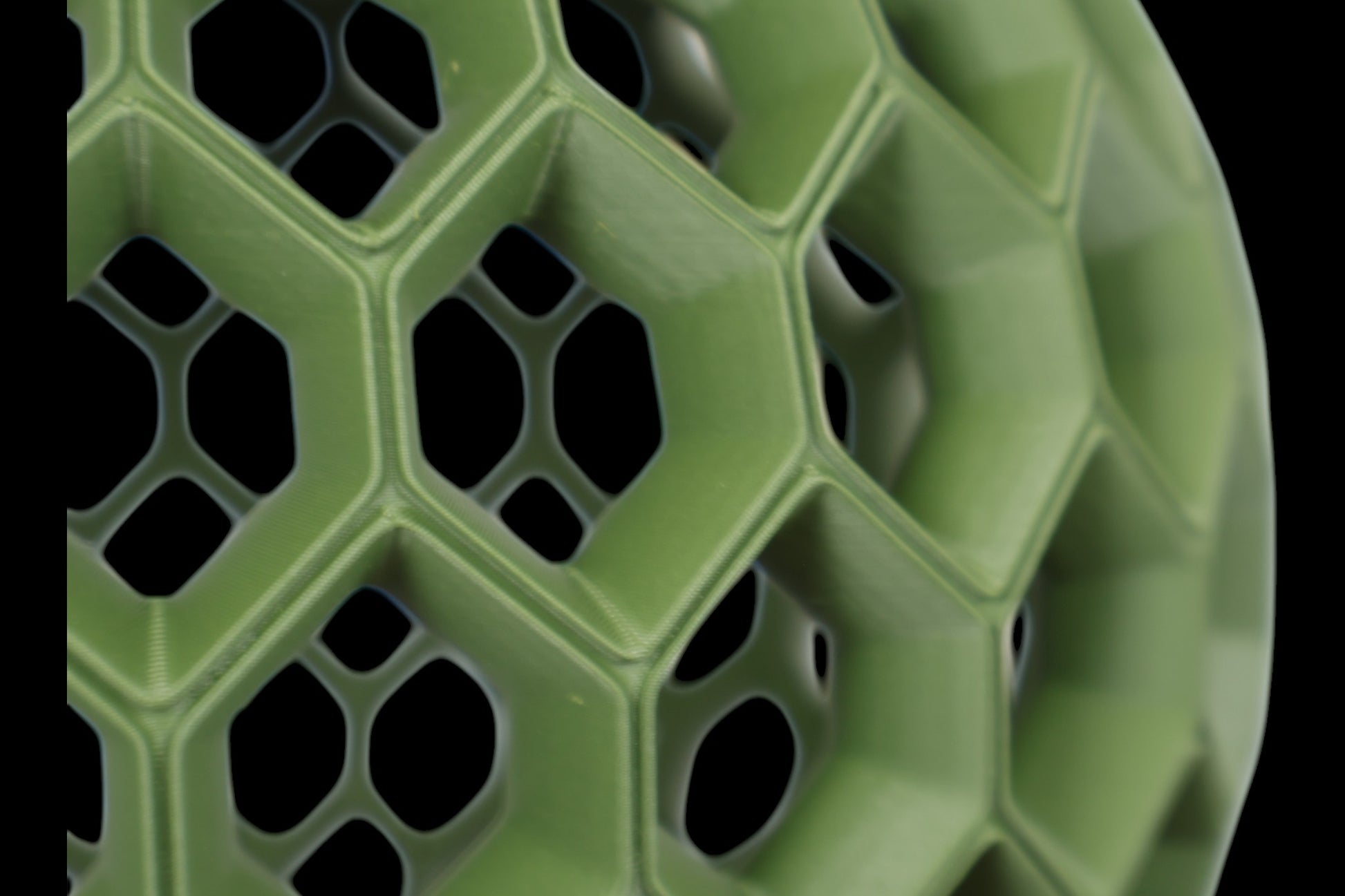 Pendant lamp – 3D printed with green honeycomb shell featuring hexagonal and pentagonal openings, black top mount
