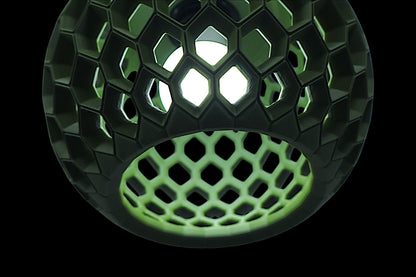 Pendant lamp – 3D printed with geometric honeycomb shell, internal bulb casts light through hexagonal and pentagonal cutouts
